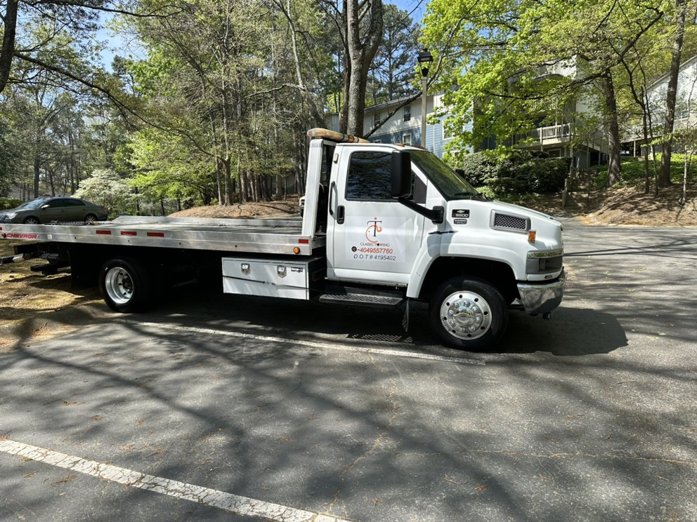 Classic Towing Chevrolet 5500 flatbed tow truck parked on a neighborhood street