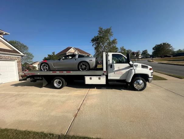 Sports car loaded on a Classic Towing flatbed in a suburban driveway