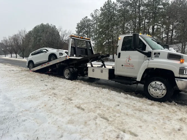Snow-day emergency towing of an SUV along a Georgia roadside